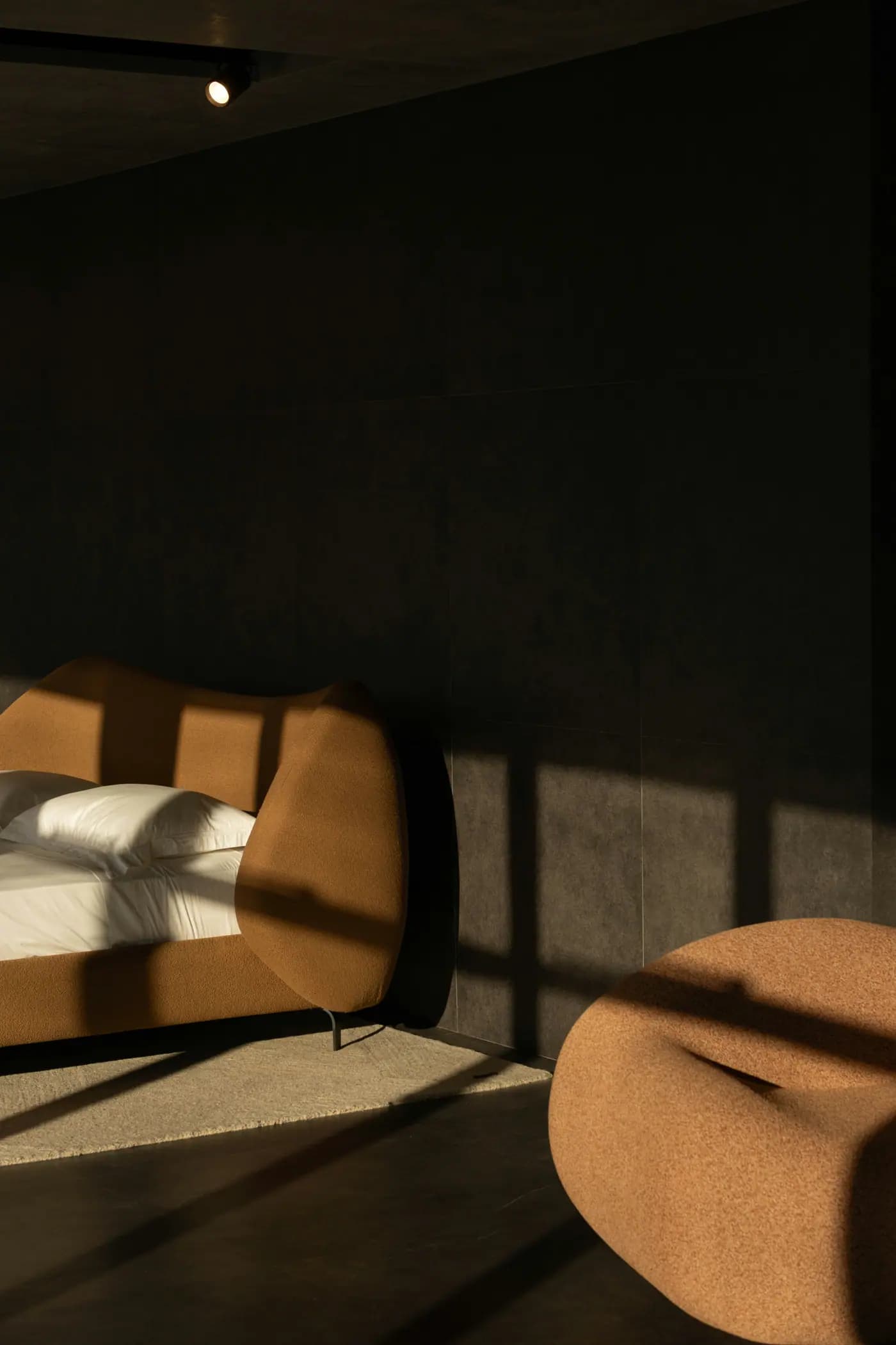 Modern furniture bathed in dramatic sunlight inside a minimalist room.